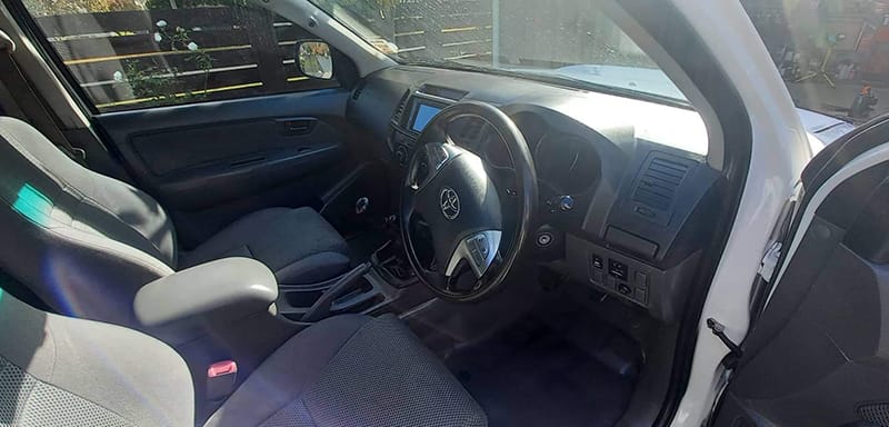 Vehicle interior fabric being shampooed and leather conditioned